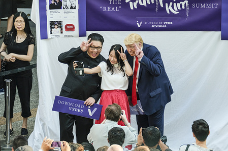 Hong Kong-based Kim Jung-Un impersonator Howard X, and Trump lookalike Dennis Alan seen having photos taken with the singaporean locals as the real US president Donald Trump and the North Korean leader Kim Jung Un touched down in Singapore for their historic summit.