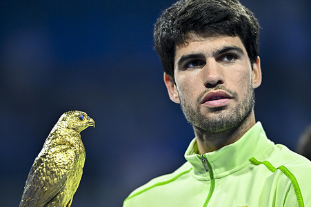 Carlos Alcaraz of Spain celebrates with the trophy after winning his men's singles final match against Arthur Fils of France at the ATP Qatar Exxonmobil Open 2026 tennis tournament at the Khalifa International Tennis Complex. Carlos Alcaraz won against Arthur Fils 6-2,6-1.    