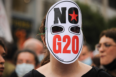 A protester wears a mask with "No G20" written on it during the demonstration.
A network called "BeesAgainstG20", including several environmentalist associations and green movements, such as Friday for Future staged a protest in Piazza Dante (Dante Square) against the G20 Environment, Climate, and Energy Meeting in Naples.