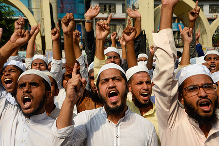 Muslim protesters chant slogans during the protest against French president Emmanuel Macron in Dhaka.
Thousands of Muslim protesters hold a march calling for the boycott of French products and denouncing French president Emmanuel Macron for his remarks ‘not to give up cartoons depicting Prophet Mohammed’. Macron's remarks came in response to the beheading of a teacher, Samuel Paty, outside his school in a suburb outside Paris earlier this month, after he had shown cartoons of the Prophet Mohammed during a class he was leading on free speech.