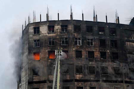 Firefighters try to extinguish a fire inside the building after a fire broke out at a factory named Hashem Foods Ltd in Rupganj of Narayanganj district on the outskirts of Dhaka.
At least three people have been killed, 20 others injured and many are feared trapped after a massive fire raged through a factory, the cause of the fire which originated at a ground floor of a multi storey building of the factory is not yet known.