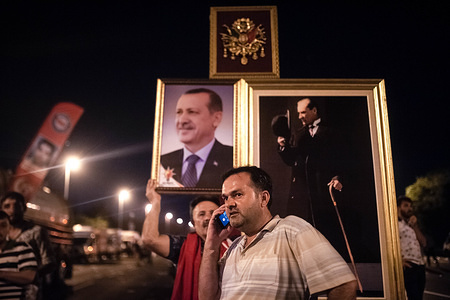 A Turkish man seen carrying the portrait of the Turkish president Recep Tayyip Erdogan during the National Unity day.
A large crowd of people gathered for the Meeting at "July 15 Martyrs Bridgeí, previously known as Bosphorus Bridge. The celebration commemorated the second anniversary of the attempted coup between 15 and 16 July 2016, in which early 250 people died in the coup and approximately 2,200 were wounded. Since then the government launched a crackdown on those reportedly affiliated with coup organizers, which caused the arrest of nearly 50, 000 and a massive dismissals of State employees.
Following the celebration the crowd visited the new monument for the martyrs, donated by the religious Semerkand Foundation (Semerkand Vakfi)