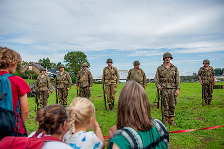 Families are seen observing the WW II reenactors. This month marks 82 years since the troops of the American 82nd Airborne Division crossed the Waal River in Nijmegen to liberate the city from the German occupiers. A World War II encampment was recreated on the riverbank, where reenactors took visitors back in time with living history.
