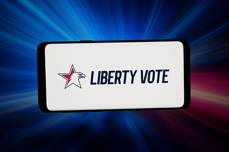 In this photo illustration, the logo of US voting systems company Liberty Vote is displayed on a smartphone in front of abstract background on computer screen.