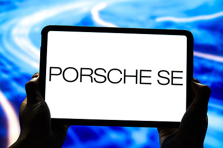 In this photo illustration, the Porsche SE logo is displayed on the screen of a smart tablet.