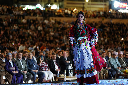 A Kurdish woman presents a traditional outfit during the third edition of the (Shal Shabek), the Kurdish costume festival in the city of Zakho in Kurdistan Region of Iraq. A two-day festival, which features international Kurdish participation from Turkey, Syria, and Iran, as well as the host country Iraq, where Kurds reside, aims to showcase the diversity and cultural heritage of Kurds in these countries to the world.