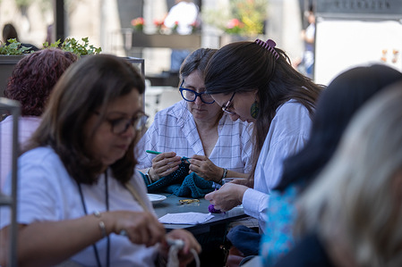 A group of women take part during the event. World Wide Knit in Public Day, is celebrated annually on the second Saturday of June. In Madrid, a group of women celebrate World Wide Knit in Public Day on a terrace in the Plaza Mayor.