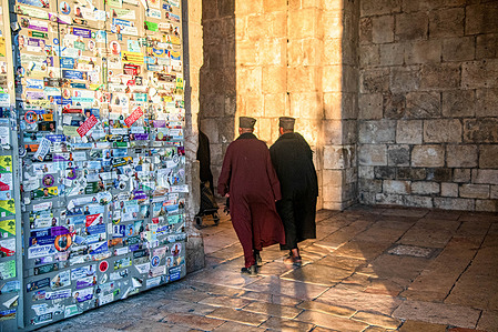 Priests enter the Jaffa Gate, one of the gates at the entrance to the Old City of Jerusalem, the gate where hundreds of commemorative stickers were affixed in memory of the fallen of the Iron Swords War.