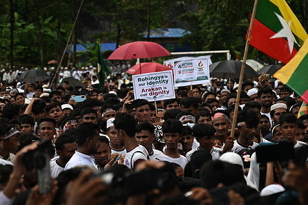 Rohingya refugees hold placards and flags during a "Genocide Remembrance Day" rally at a refugee camp in Cox's Bazar. Tens of thousands of Rohingya refugees gathered at camps in Cox’s Bazar, Bangladesh, to mark the ninth anniversary of "Rohingya Genocide Remembrance Day." The rally commemorated the 2017 mass exodus triggered by a brutal Myanmar military campaign in Rakhine State, with demonstrators uniting to demand international protection, restoration of their citizenship rights, and a safe, dignified return to their homeland.