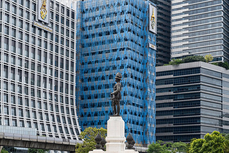 The Rama VI Monument at the entrance to Lumphini Park with King Chulalongkorn memorial hospital and modern Blue Building near Silom in central Bangkok.
