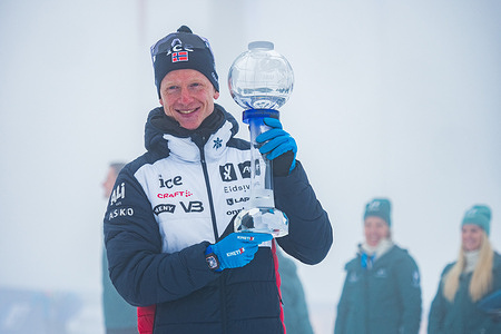 Norwegian athlete Johannes Thingnes Boe receiving a big crystal globe for winning world cup total score after finsihing the Men 12.5 km Pursuit at the BMW IBU World Cup.