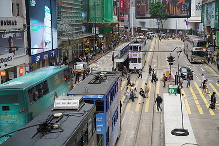 Trams seen driving on Yee Wo Street at Causeway Bay. A double-decker "Ding Ding" tram maneuvers through the narrow, bustling corridors of Des Voeux Road Central serving as a slow-moving observer to the city's rapid modernization. Operating since 1904, the Tramways remains the world’s largest operational fleet of double-decker, offering a rhythmic, low-cost link between the island's colonial past and its status as a global financial hub. As the tram’s signature bell chimes to alert pedestrians, passengers on the upper deck are granted a "grandstand" view of the vibrant street life and towering skyscrapers that define the northern coastline of Hong Kong Island.