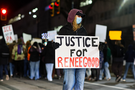 Anti-ICE protesters hold placards as they block traffic on College Avenue. The protest was organized by the Student Committee for Defense and Solidarity in response to an ICE agent killing Renee Nicole Good in Minneapolis.