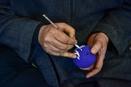 A Kashmiri artisan makes the final touches on a papier-mache product before sending it to the market. The centuries-old papier-mâché art form, which is deeply interwoven with the culture and traditions of Kashmiri society, is dying a slow death as the people involved in the trade decrease. Thousands of families in Kashmir earned their livelihood by selling and making papier-mache items. The emergence of the art of papier-mache accompanied the advent of Islam in the region. It was introduced to Kashmir by Sufi scholar Mir Sayyid Ali Hamdani who arrived from Persia with skilled craftsmen in the 14th century.