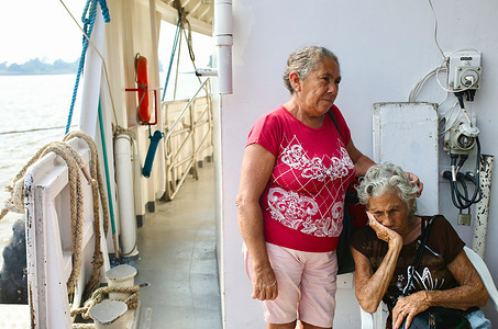 On the deck of Pope Francisí hospital boat, two patients wait for their medical appointment. In Monte-Alegre, Brazil, in the middle of the Amazon rainforest, the Pope Francis hospital boat, founded and run by the Fraternity of Saint Francis of Assisi in the Providence of God, meets local inhabitants to make up for the lack of health infrastructure in a region marked by mining and the effects of climate change.