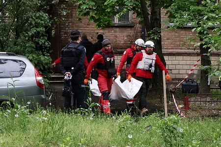 Emergency workers carry the body of a resident who died when a Russian drone hit an apartment building, amid Russia's attack on Ukraine. Russia launched new nighttime airstrikes on the Ukrainian capital, killing two people in the strikes on Kyiv. Falling debris from destroyed drones sparked fires in apartments and buildings across three of Kyiv's districts, killing two people in the busy, urban Shevchenkivskyi district, Ukraine's emergency service said on.