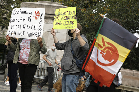 Demonstrators hold up placards in Central Park in protest of the Supreme Court nominee, Amy Coney Barrett, violence against women and forced hysterectomies of immigrant women.