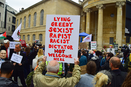 A protester holds a placard making his feelings known about Trump during the demonstration near BBC headquarters. Thousands of people marched against Donald Trump in Central London as the US President arrived in Windsor for his second state visit to the UK.