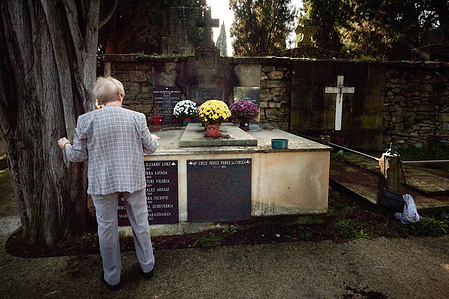 A lady decorates the tomb of her relatives with flowers in the Cemetery of Pamplona, during the celebration of All Saints' Day. Every 1st of November, in the Catholic religion, All Saints' Day is celebrated, a Christian custom where the faithful go to cemeteries to take flowers to their loved ones who are no longer among the living.