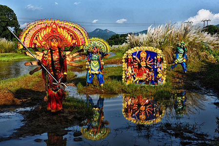 Chhau artists are seen showing their skills and performance with an idol of Hindu goddess Durga. Catkins or Kashful are usually seen along the river banks during autumn. The annual Durga Puja festival is one of the most popular festivals for Hindus. In Hindu mythology, the Hindu goddess Durga symbolizes power and the triumph of good over evil.
