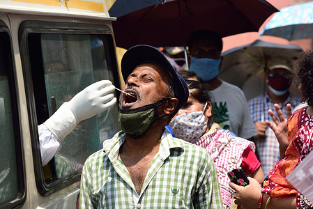 A healthcare worker collects swab samples from a man for RTPCR covid 19 tests.
There has been a scarcity of hospital beds reported in Kolkata as well as other Indian states along with medical oxygen.