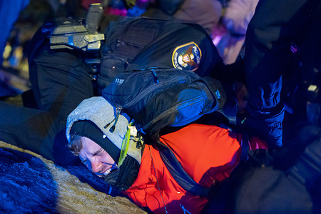 A man is arrested after a confrontation with police outside the Whipple Federal Building A judge issued a restraining order on Friday that bans federal agents from arresting or using chemical irritants against peaceful protesters.