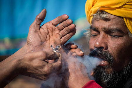 A Sadhu or holy man smokes marijuana using a chillum (traditional clay pipe) as a holy offering during the festival at premises of Pasupatinath Temple.Maha Shivaratri is one of the biggest Hindu festivals celebrated annually in honor of Lord Shiva and in particular, marks the night when Shiva performs the heavenly dance.