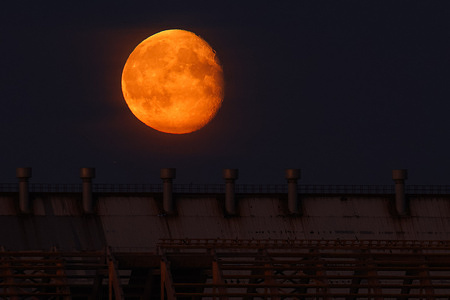View of the rising Moon during evening time in St. Petersburg. Four supermoons in 2024. A supermoon is an astronomical phenomenon when the full moon coincides with the passage of the point of closest approach of the Moon and Earth - perigee. The next supermoon will take place on October 17, 2024.