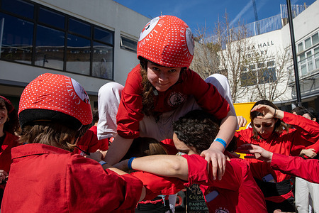 The Castellas of London build a human pyramid during a performance at the Blue market in Bermondsey in London. Established in 2015, Castellers of London are dedicated to preserving and performing the centuries-old Catalan tradition of human tower building. While the group includes many members from Catalonia, it also brings together participants from a broad mix of nationalities. On Saturday 21st March 2026, they gave a performance at Blue Market Bermondsey, constructing several human towers and highlighting their coordination, skill, and cultural heritage.