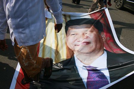 Demonstrators seen stepping on the portrait of Chinese president Xi Jinping during a protest by Indonesian Muslims criticizing the Chinese government's policy on Uighur Muslims which is believed to be part of a policy of intimidation towards Muslim minorities in China. The end of the demonstration led to the burning of a photo of the president of China on the highway.