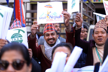 Nepali nationals smile with a placard during the campaign.
Nepali nationals participate in a campaign in Kathmandu aimed at boosting local and international tourism in Nepal dubbed ‘Visit Nepal 2020’ that was organised by the government.