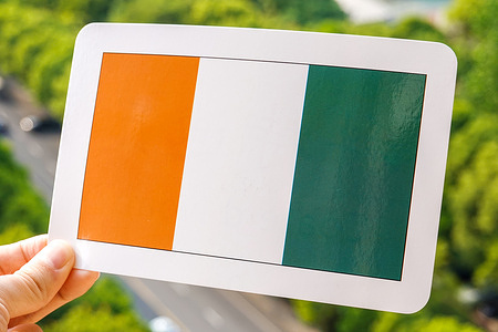 In this photo illustration, the flag of Cote d'Ivoire is printed on a white card.