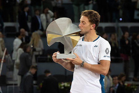Norwegian Casper Ruud celebrates with the trophy after his victory against British Jack Draper after the men's singles final on day thirteen of the Mutua Madrid Open at La Caja Mágica. Final score: 7-5, 3-6, 6-4 to 6-3, 7-6 for Ruud.