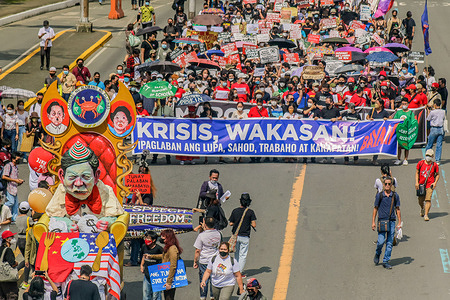 Protesters march through the street while holding placards and a banner during the demonstration. Protesters gather in Metro Manila to express their opinions hours before the first State Of The Nation Address (SONA) of Philippine President Ferdinand Marcos Jr. The protest focused on human rights violation of Marcoses, rejecting the Marcos-Duterte government, short-term employment, red-tagging and historical distortion which they believe can happen under the leadership of Marcos Jr.