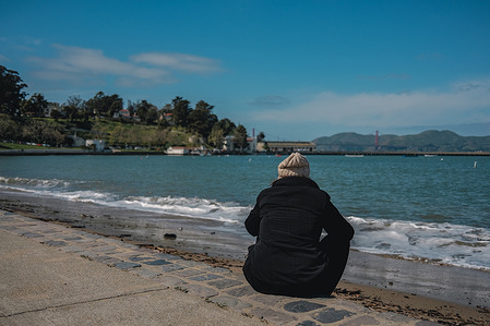 People sit on the beach at Ghirardelli Square, enjoying a beautiful view of the San Francisco Bay and the ocean beyond. Ghirardelli Square, located in San Francisco's iconic Fisherman's Wharf neighborhood, is a historic landmark that has been delighting locals and tourists alike for over 50 years. Originally built in 1893 as the headquarters of the Ghirardelli Chocolate Company, the square has undergone numerous renovations and changes over the years, but has remained a beloved destination for shopping, dining, and entertainment.