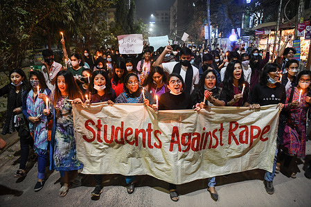 Female activists and students hold a banner, placards and lit candles during the demonstration.
Female activists and classmates take part in a candlelight protest demanding justice for the schoolgirl who died due to excessive bleeding after she was raped in Dhaka, Bangladesh.
