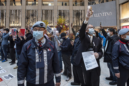A security guard with a face mask during a protest calling on the government to close the border with China. 
Dozens of demonstrators protested at the Landmark shopping mall in Central demanding for the Hong Kong government to close all the borders in Hong Kong connecting with Mainland China in order to control the deadly Corona virus from spreading into Hong Kong.