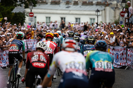 Cyclists ride past the crowd during the last stage of Tour de France 2026 at the Montmartre neighbourhood. Dutch rider Mathieu van der Poel (Alpecin–Premier Tech) won Stage 21 of the 2026 Tour de France, while Tadej Pogačar secured his fifth overall Tour de France title, equaling the record for the most General Classification victories. The race's final stage once again passed through Montmartre and the Rue Lepic climb before finishing on the Champs-Élysées, drawing thousands of spectators.