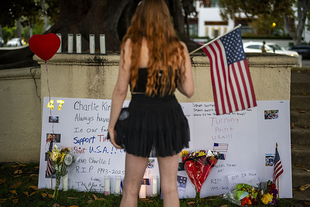 A woman visits a memorial for Charlie Kirk in Beverly Hills on Sept. 14, 2025. Kirk, CEO and co-founder of Turning Point USA, was shot and killed Wednesday in Utah.