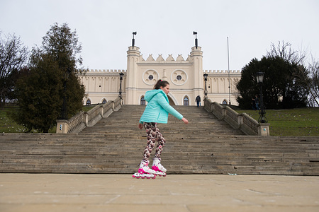 A girl with rollerblades is seen in the old town in Lublin.
Poland is a country located in central eastern europe neighbouring Germany to the west and Ukraine to the east.