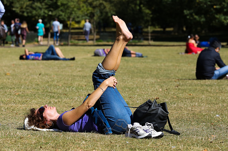 A woman exercises at St James' Park during the sunny day.
According to the Metrological Office, the temperature is likely to reach 25 degrees Celsius this weekend in many parts of UK.