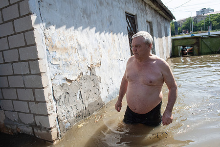 A man waded up to his home in flood waters to retrieve belongings in Kherson after the bursting of the Kakhovka Dam. Massive flooding has occurred in villages along the Dnipro River after the destruction of the Kakhovka Dam, inundating communities along the river in the south, and dangerously dropping water levels in the communities in the north. Kakhovka Dam is in the Russian-controlled area of southern Ukraine. According to media reports, Ukraine's military and Nato have accused Russia of blowing up the dam, while Russia has blamed Ukraine. As of June 8 reports, at least 7 are missing, 136 sustained injuries, and around 2,900 people are displaced.