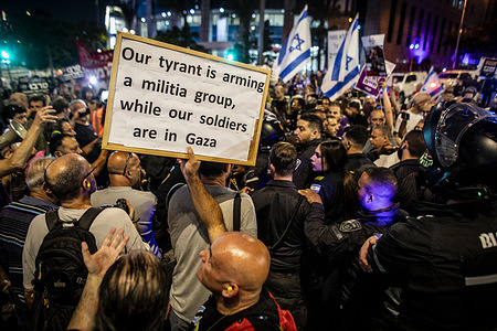 A protestor holds a placard during a demonstration calling on Israeli PM Benjamin Netanyahu and his government, to end the war in Gaza and to sign a hostage release deal. Seventeen European Union countries are actively reviewing Israel's adherence to human rights obligations under the EU-Israel Association Agreement, raising the possibility of targeted sanctions in response to its ongoing military operations in Gaza.