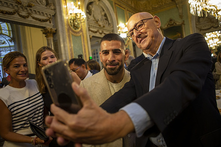 A man takes a selfie with Ilia Topuria, UFC lightweight world champion during a breakfast briefing at the New Economy Forum at the Real Casino.