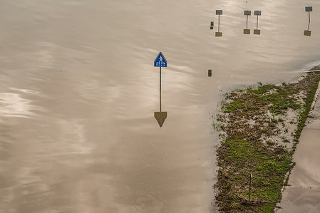 View of a flooded street and signs of Han river park after heavy rains.
15 dead and 11 missing were reported after heavy rain triggered floods and mudslides.