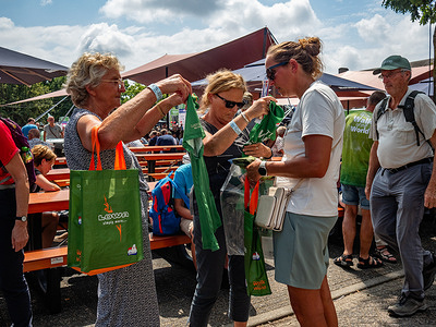 Participants are seen holding official t-shirts. Around 47.000 participants (including the Armed Forces from other countries) registered for the International Four Days Marches (Vierdaagse), the largest multi-day walking event in the world. Walkers picked up their wristbands with the number of registrations at the start point of the walk.
Depending on their age and sex, they walk a total of 120, 160, or 200 kilometres towards the Via Gladiola. This year, it's the 107th edition.