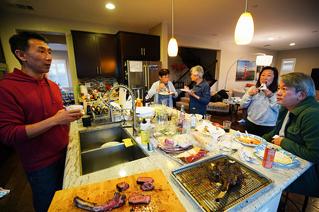 Albert talks with family and friends as they eat and drink during the Independence day celebrations. Albert, an American Chinese living in San Francisco Bay Area for more than twenty years, invited his families and friends to celebrate the independence day through a party at his residence. They celebrated the day with eating, drinking and playing games.4th of July, also called "Independence day" or "national day" in the United States, is a very important day for the United States and most of people, either white, black or Asian celebrate this day publically or with their families and friends.