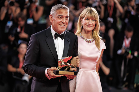 American actor and producer, George Clooney and american actress, Laura Dern seen holding the Honorary Golden Lion Award at the 83rd Venice International Film Festival at the Palazzo del Cinema.