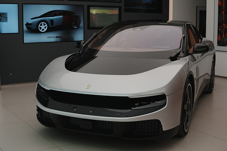 A Ferrari Luce is displayed as the automaker's first all-electric model at the event.