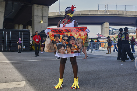 A fan of Korean pop musicians, BTS, dresses as a chicken seen during the second day of the band's shows in Baltimore. The bands has been on a world tour in support of their most recent album, Arirang. Diehard fans, who call themselves the "BTS army," traveled across the US, waiting through scorching heat and thunderstorms over the course of the two-day performance at M&T bank stadium.